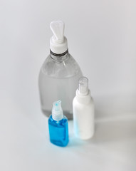 hygiene and disinfection concept - close up of different hand sanitizers on table