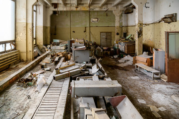 Photo of a slum in an abandoned broken devastation plant. Landfill in the workshop.