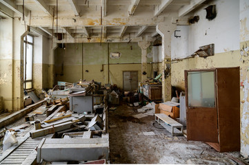 Photo of a slum in an abandoned broken devastation plant. Landfill in the workshop.