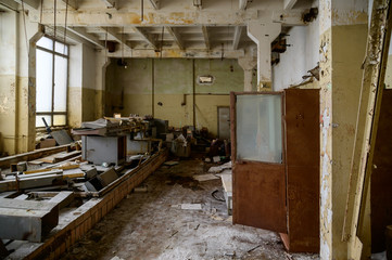 Photo of a slum in an abandoned broken devastation plant. Landfill in the workshop.