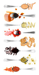 Spoons with different tasty sauces on white background