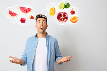 Excited young man on light background