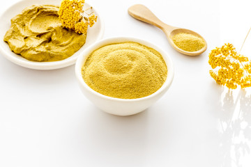 Yellow cosmetic clay - skin cleansing concept - on white background