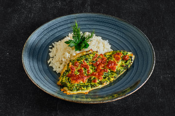 Fried fillet of white fish with spinach and cheese topping and served with rice