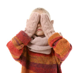 Cute little girl in winter clothes on white background