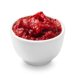 Bowl with tomato sauce on white background