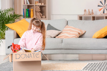 Little girl with donations at orphan home