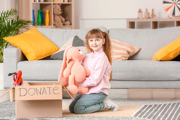 Little girl with donations at orphan home