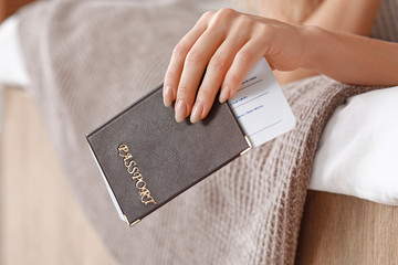 Female tourist with documents at home, closeup