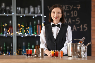 Beautiful female bartender in pub