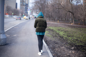 A girl is walking down the street.