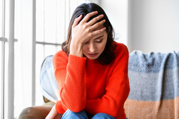 Depressed young woman at home