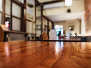 Fototapeta na wymiar Table top wooden counter Blur coffee shop cafe Interior background 