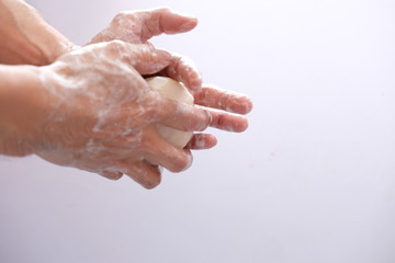 Fototapeta premium washing hands with liquid soap and sponge