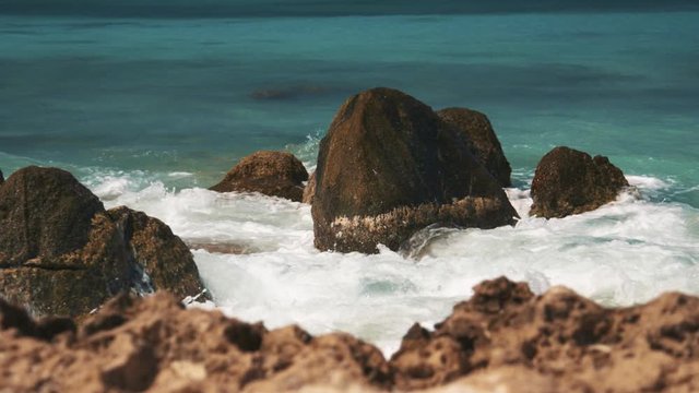 Water splashing on rocks at Arashi beach, Aruba, Caribbean