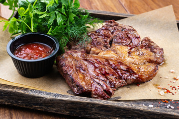 Juicy steak medium rare beef with green salad on plate. Top view, flat lay