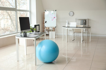 Fitness ball near workplace in office