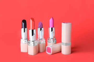 Obraz premium Different lipsticks on color background