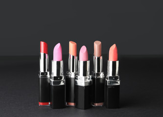 Different lipsticks on dark background