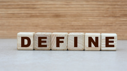 concept of the word to define on cubes on a light wooden background