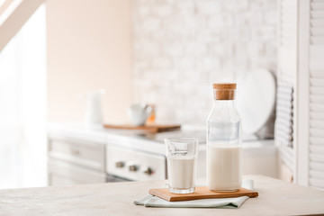 Glass and bottle of fresh milk on table