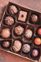 Box with delicious candies on color background