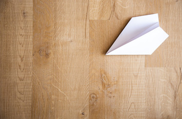 paper plane on wooden floor