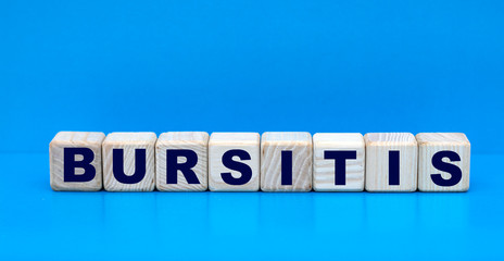 concept word BURSITIS on cubes on a blue background