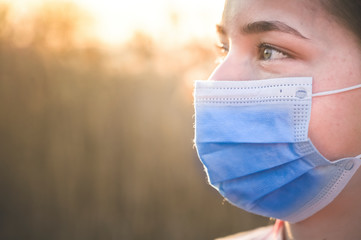 Woman wearing protective mask against coronavirus. Put mask to fight against Corona virus. COVID-19...