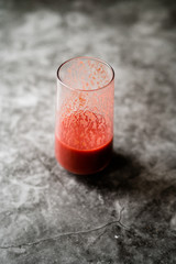 Healthy Organic Homemade Fresh Mixed Red Strawberry Smoothie with Banana, Grape, Apple and Orange in Glass.