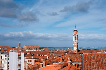 Aerial view on rooftops, Venice cityscape, the bell tower and sea on background. Italy, Europe....