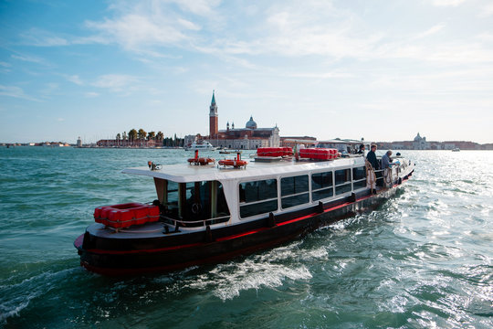 Small tourist ship in the sea near Venice. Transportation of tourists on a warm sunny day. Italy