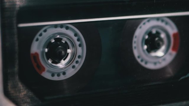 Tape Recorder Plays Transparent Audio Cassette. Vintage Audio Cassette Rotates