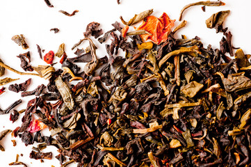 A mixture of black and green tea with vanilla-strawberry flavor, sliced strawberries and rose petals. Background for tea and antioxidants.