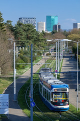 Obraz premium ZURICH, SWITZERLAND - MARCH 19, 2020: Tramway leading in the direction of the city - in the background you can see the green Prime Tower, a modern landmark of Zurich