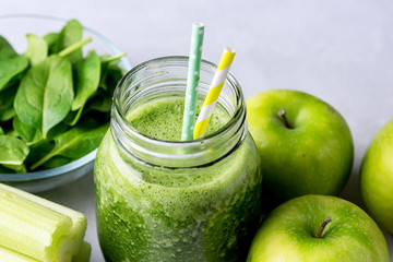Glass Jar of Healthy Green Smoothie Detox Drink wirh Green Apple Celery and Raw Spinach Diet Beverage Above Close Up