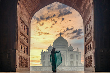 Woman in traditonal culture dress saree or sari in the Taj Mahal, Taj Mahal is most beautiful white...