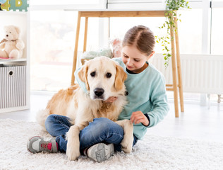 Girl holding adorable golden retriever