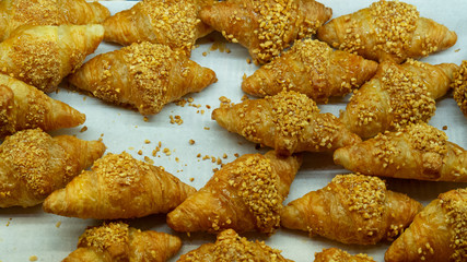 The croissant topped with several pieces of sesame seeds were piled together.
