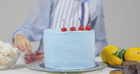 Woman chef decorating a cake, isolated on white background
