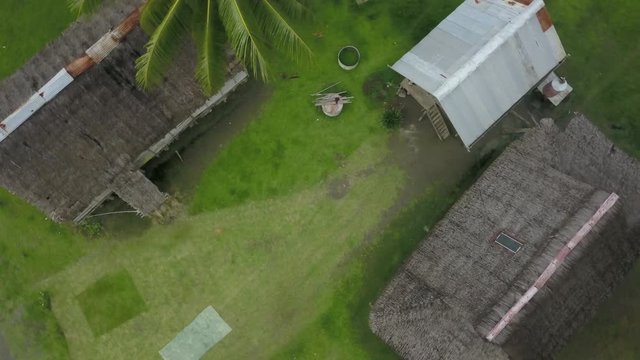 Ascending aerial shot, rotating while looking down on huts in Kanganaman Village, Sepik Region, Papua New Guinea