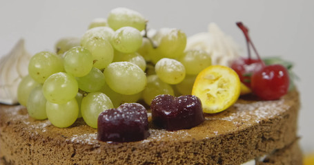 Cheesecake with grapes and powdered sugar. Shallow dof.