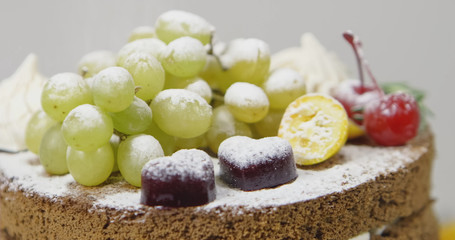 Cheesecake with grapes and powdered sugar. Shallow dof.