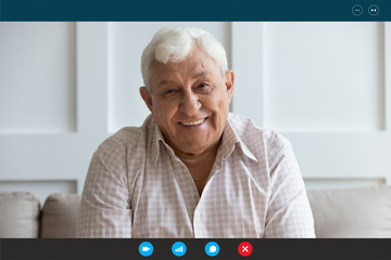 Head shot screen software application view happy middle aged elderly man communicating chatting talking speaking with grown up children family or friends online, staying at home during quarantine.