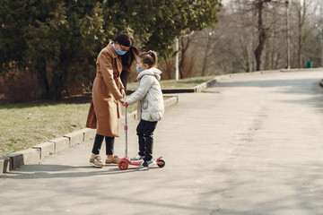 Family walks outside. Coronavirus theme. Mother with daughter.