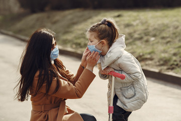 Family walks outside. Coronavirus theme. Mother with daughter.