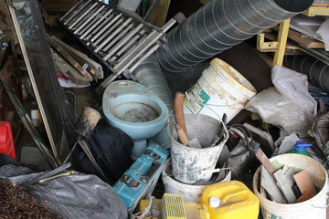 Big mess in an over stuffed suburban garage.