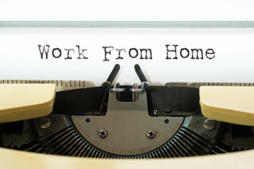 Work from home word typed on a yellow vintage typewriter. Business concept.