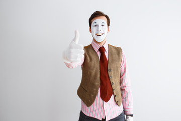 Portrait of man, actor, pantomime, man making class gesture, thumb up. Emotions, facial...
