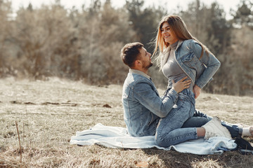 Woman in a jeans clothes. Couple in a spring forest.